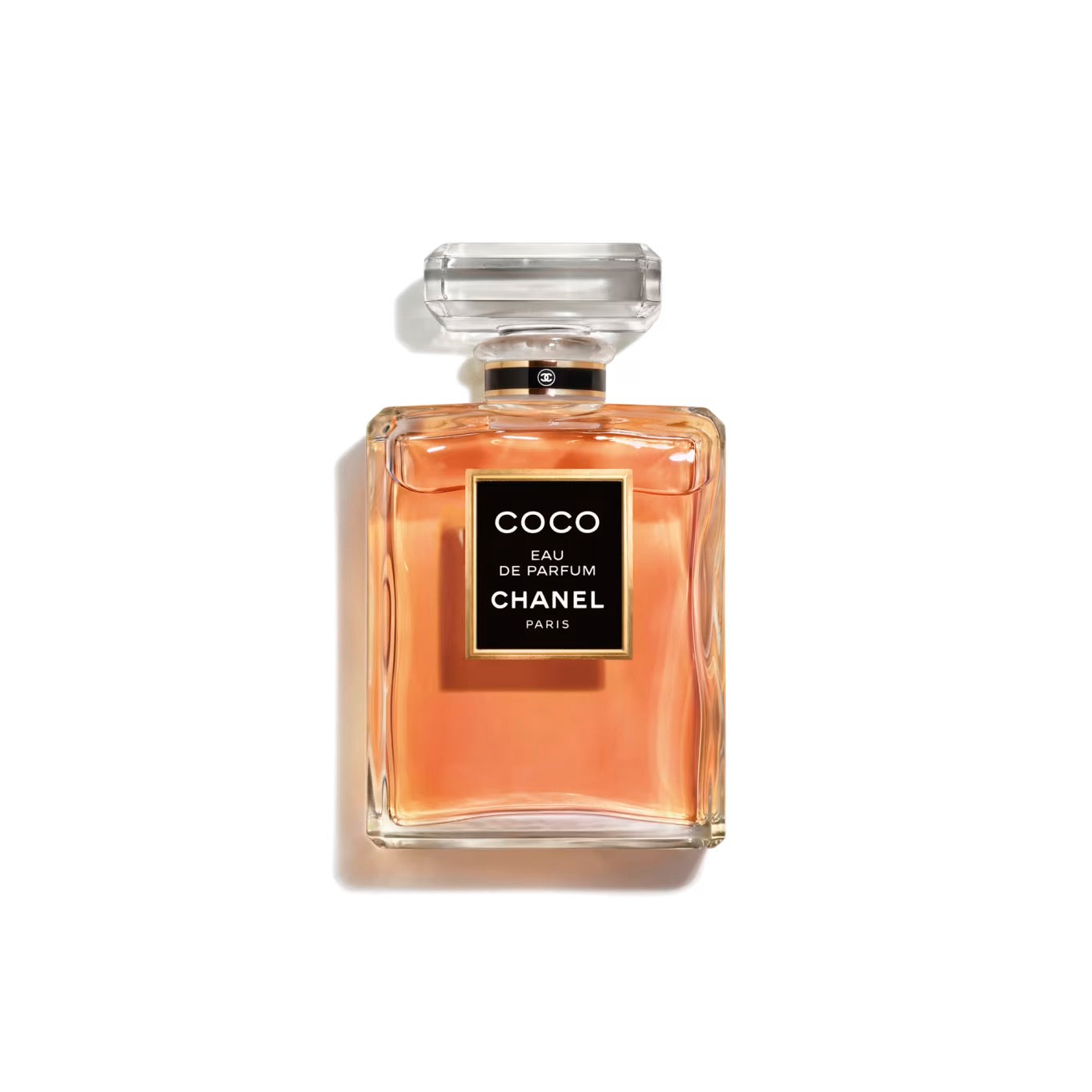 100ml clear rectangular Chanel bottle with amber liquid, a black and gold label, and a clear octagonal cap.