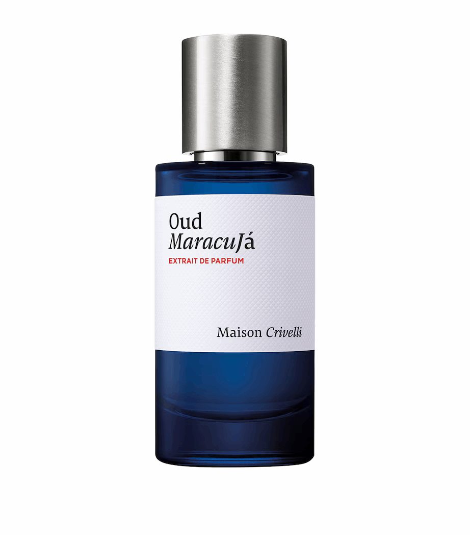 50ml cylindrical deep blue glass bottle with a white textured label, and a brushed silver cap.
