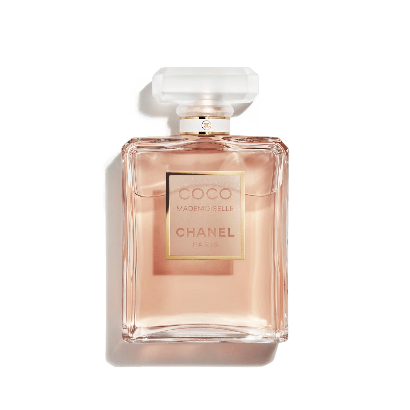 A bottle of COCO Mademoiselle perfume by Chanel with a pink-tinted liquid visible through the clear glass bottle, featuring a white cap and a gold label.