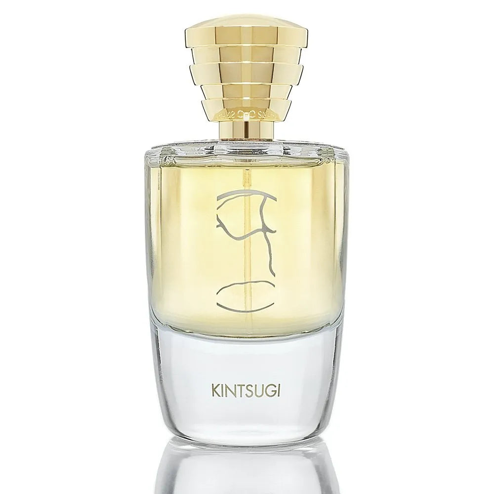 Kintsugi by Masque Milano Perfume bottle with gold cap and clear body on a white background