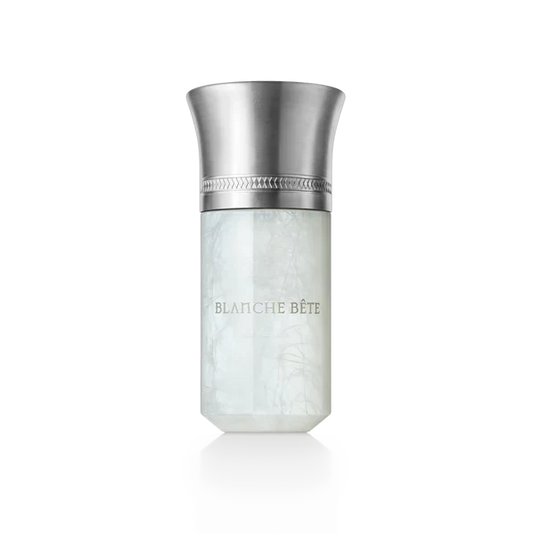 A bottle of Blanche Bîte perfume with a white label and a metallic cap.