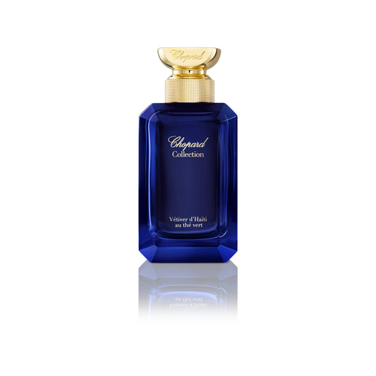 Vetiver d'Haïti au Thé Vert by Chopard perfume bottle with blue glass and gold cap on a white background