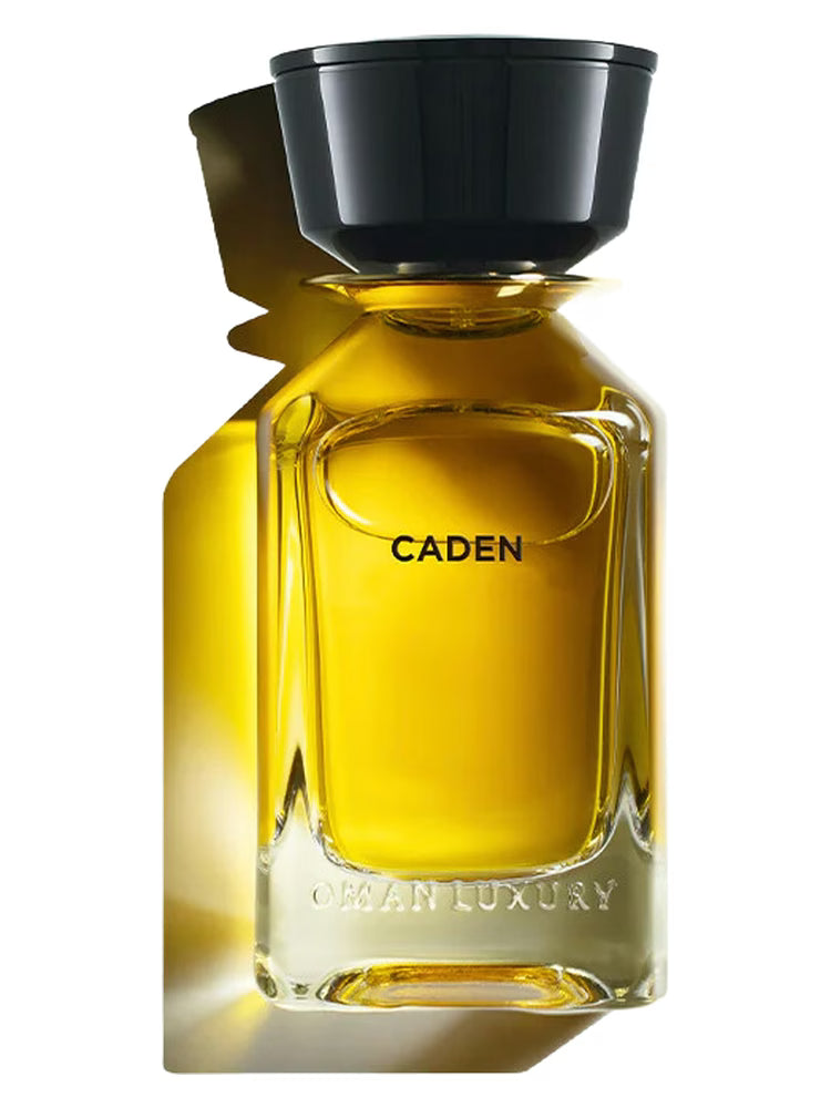 100ml clear glass bottle with amber liquid, a large black cylindrical cap, and "CADEN" printed in black.