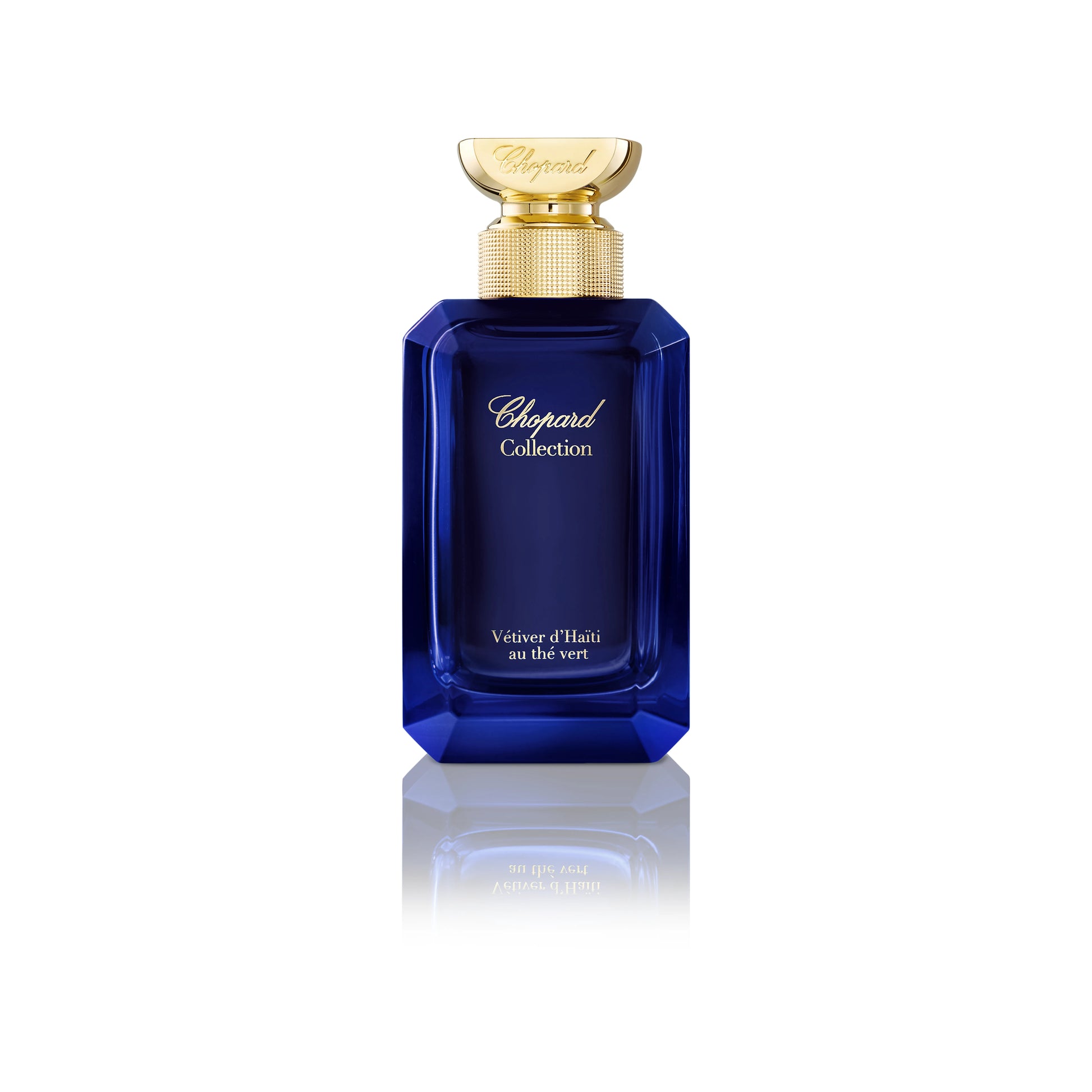 100ml tall blue glass Chopard bottle with gold neck and faceted blue cap.