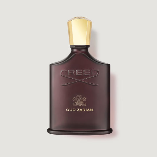 100ml Creed Oud Zarian glass bottle featuring a gold label and signature black crown cap.