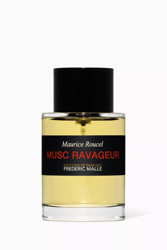 A cylindrical clear glass bottle of Frederic Malle Musc Ravageur 100ml from France, featuring a red and black label with a simple black cap, shown as a product tester.