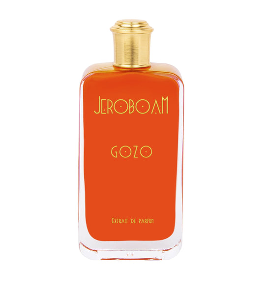 Orange perfume bottle with gold cap on a white background