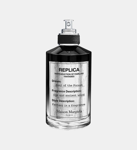 A dark green gradient glass bottle of Maison Margiela Replica Soul of the Forest 100ml from France, featuring a black textured label and silver spray nozzle.