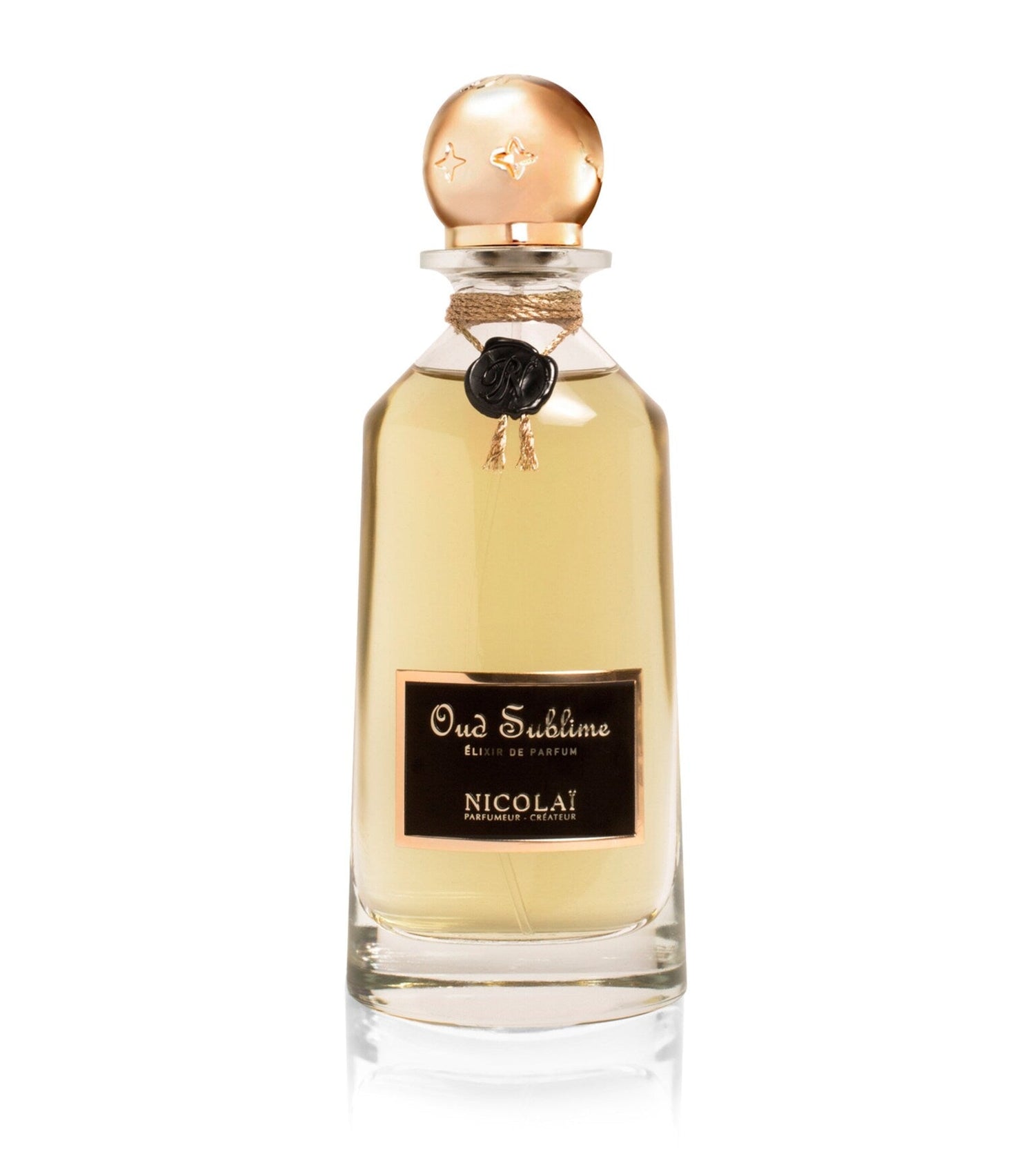 35ml clear glass bottle with a gold sphere cap, a black wax seal on a gold cord, and a black and gold label.