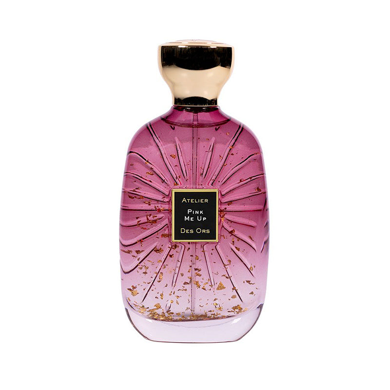 100ml curved pink glass bottle with gold flakes, a black square label, and a gold bulbous cap.